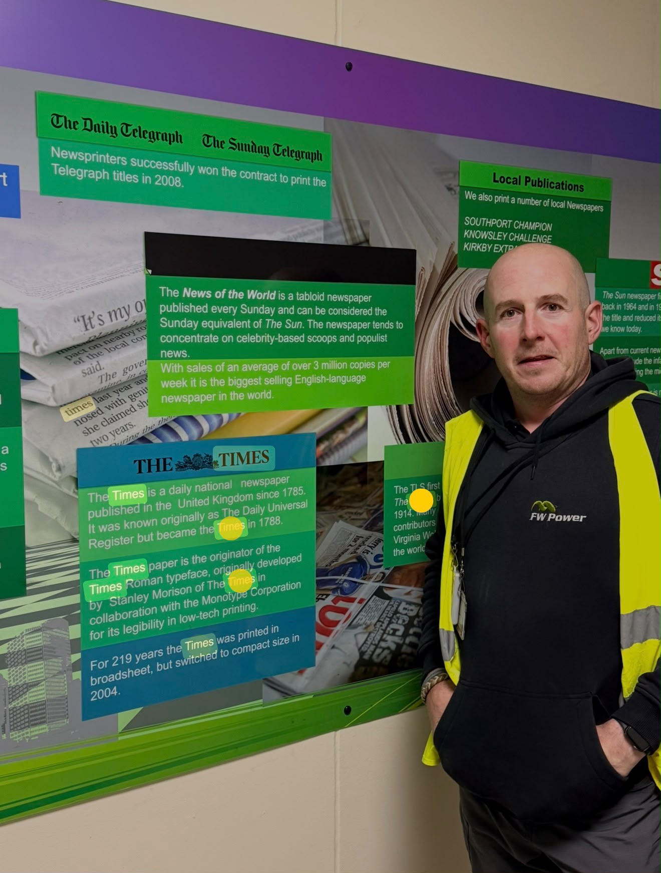 FW Power team member in a high-visibility vest at the newspaper printing facility