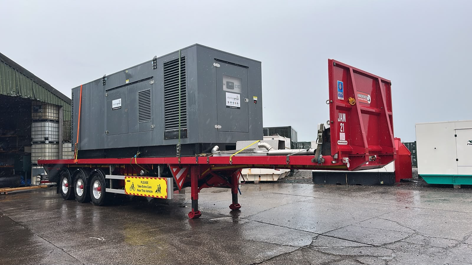FWC003 Shenton generator secured to a flatbed trailer in the FW Power yard